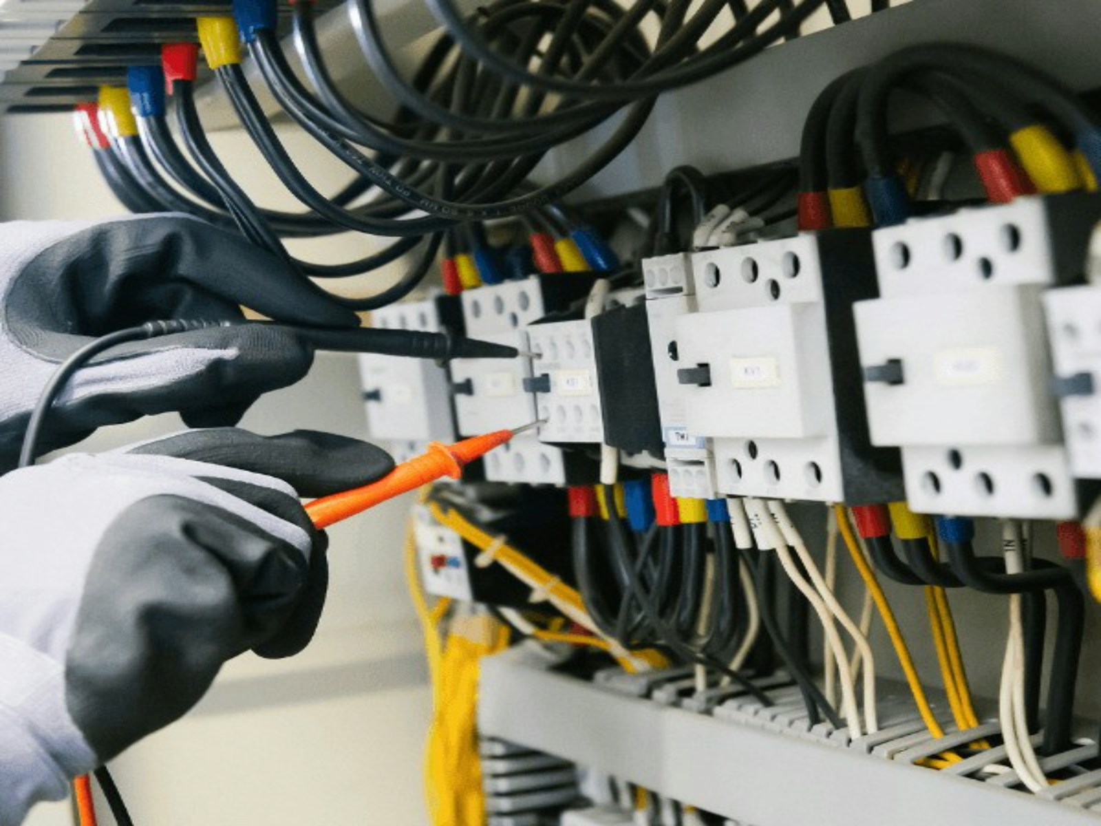Electrical wiring inside a control panel being inspected
